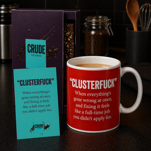 Group shot of luxury brownie box, Postcard and mug all with May's word "Clusterfuck"